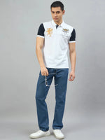 Man in a 98degreenorth Men's White Black Sleeve Aeronorth 91ª Polo T-Shirt, blue jeans, and white shoes.
