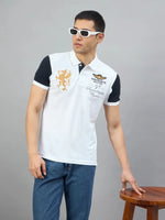 A man in sunglasses and a Men's White Black Sleeve Aeronorth 91ª Polo T-Shirt by 98degreenorth poses on a stool.