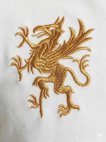 Gold griffin dragon embroidery on the 98degreenorth Men's White Black Sleeve Aeronorth 91ª Polo T-Shirt.