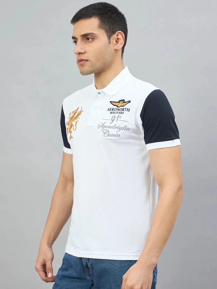 Man in 98degreenorth Men's White Black Sleeve Aeronorth 91ª Polo T-Shirt, standing against a plain gray background.