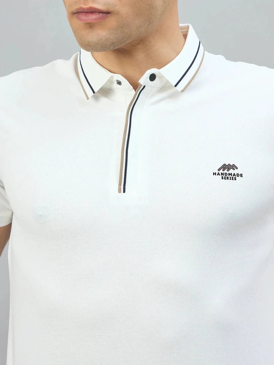 Man wears 98degreenorth Handmade Series White Polo with contrast tipping and logo from 98 Degree North.