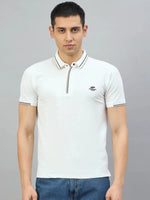 Man wears 98degreenorth Men's White Polo T-Shirt — Handmade Series with contrast tipping, paired with blue jeans.