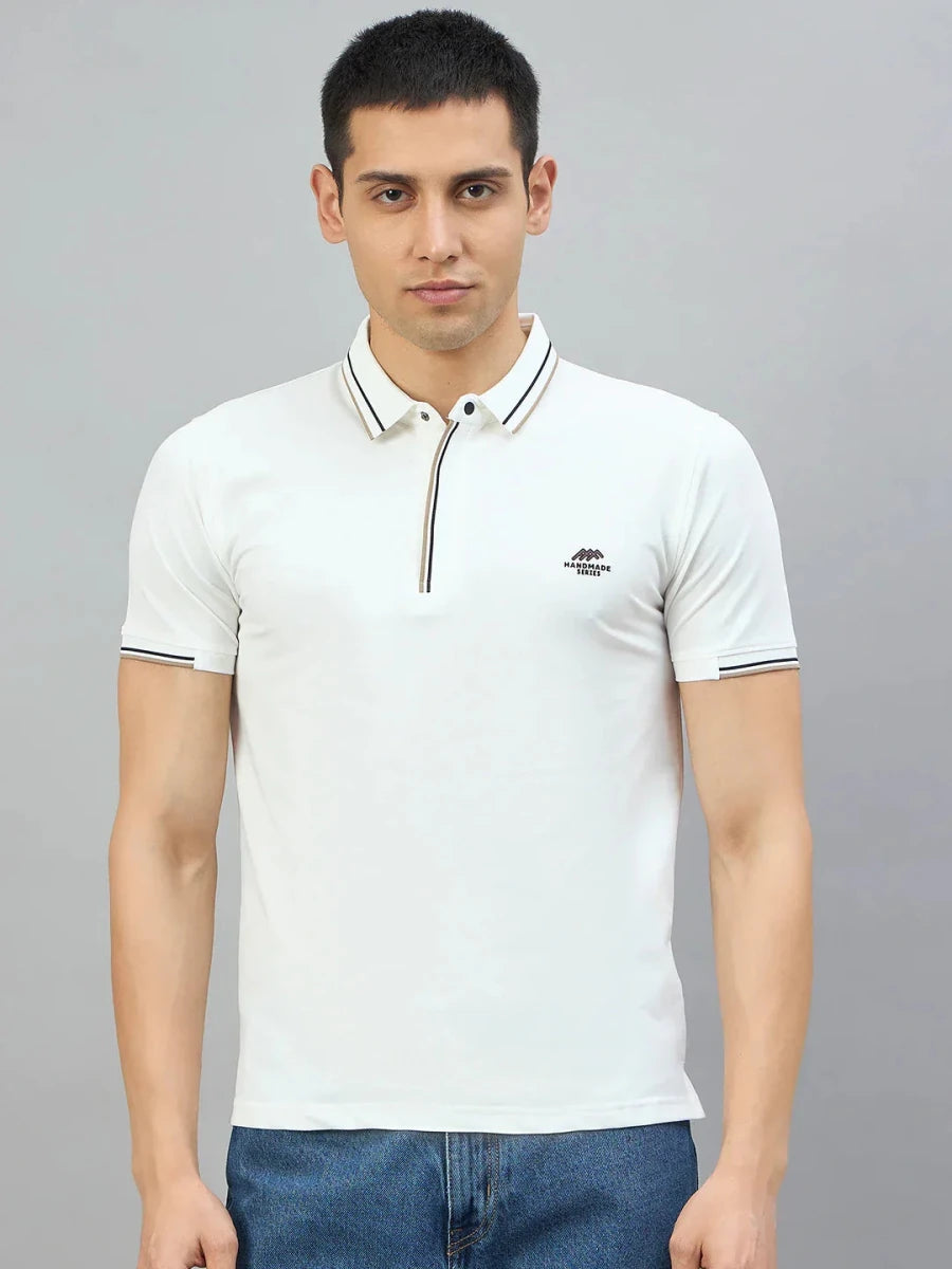 Man wears 98degreenorth Men's White Polo T-Shirt — Handmade Series with contrast tipping, paired with blue jeans.