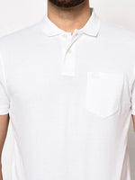 Man in 98degreenorth Men's White Polo T-Shirt—Stretch Cotton Pique with chest pocket, shown waist up.