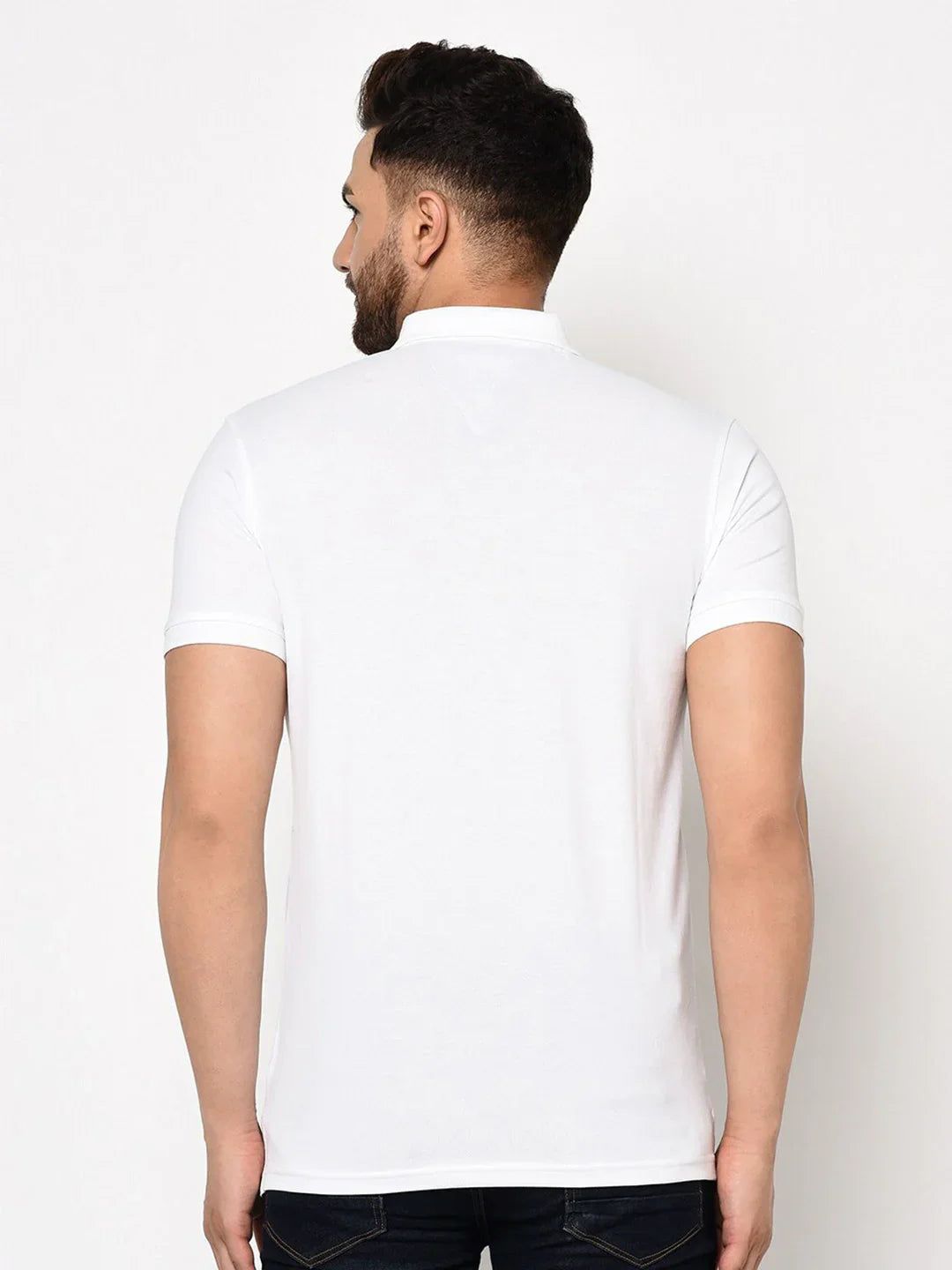 Man in a 98degreenorth stretch cotton pique white polo with chest pocket—an essential for any wardrobe.