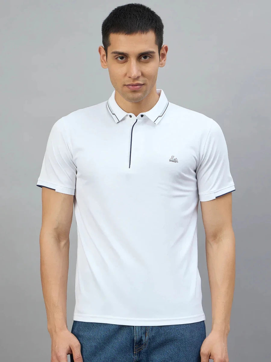 Man wears 98degreenorth Men's White Polo T-Shirt with Navy Tipping and LA logo against a plain gray background.
