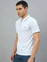 A man wears a 98degreenorth Men's White Polo with Navy Tipping and LA Logo, paired with blue jeans.