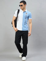 Man in 98degreenorth White Sky Blue Colour Block Polo T-Shirt, sunglasses, black pants, white shoes, and black backpack.