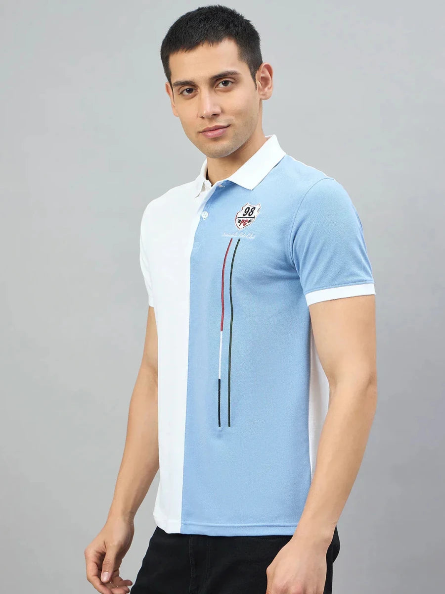 Man wears 98degreenorth Men's White Sky Blue Colour Block Polo T-Shirt in soft cotton pique.