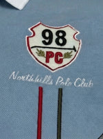 Men's white and sky blue colour block polo tee by 98degreenorth with red and white "98 PC Northhills Polo Club" patch.