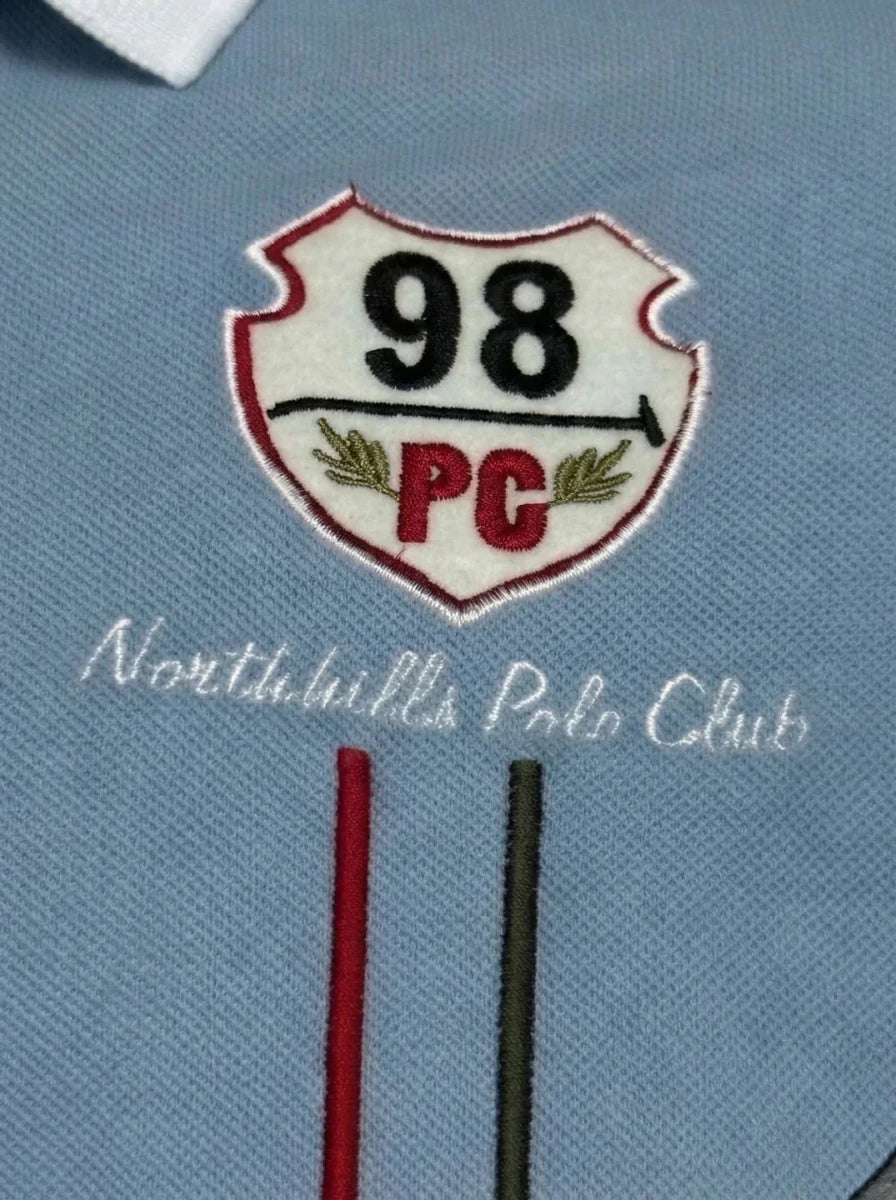 Men's white and sky blue colour block polo tee by 98degreenorth with red and white "98 PC Northhills Polo Club" patch.