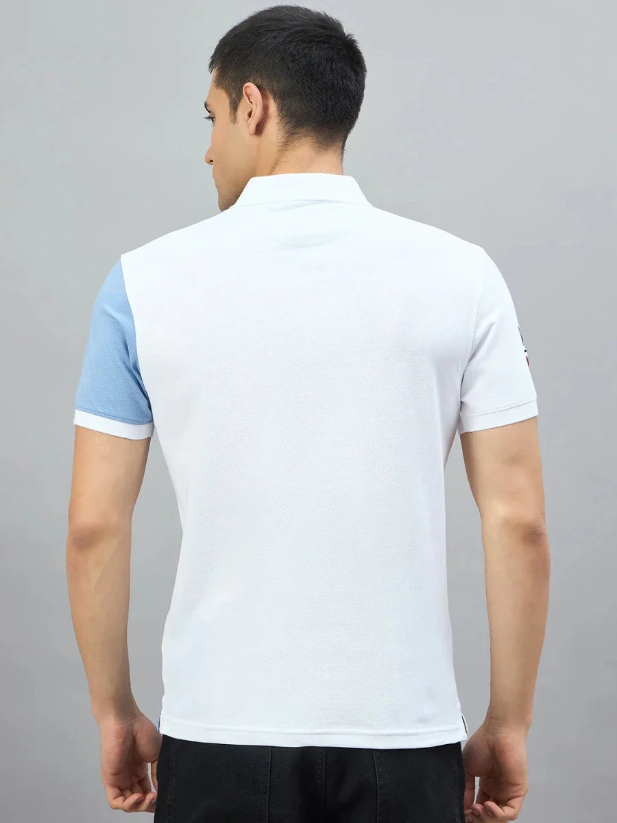 Man in a 98degreenorth Men's White Sky Blue Colour Block Polo T-Shirt, regular fit, on a plain gray background.