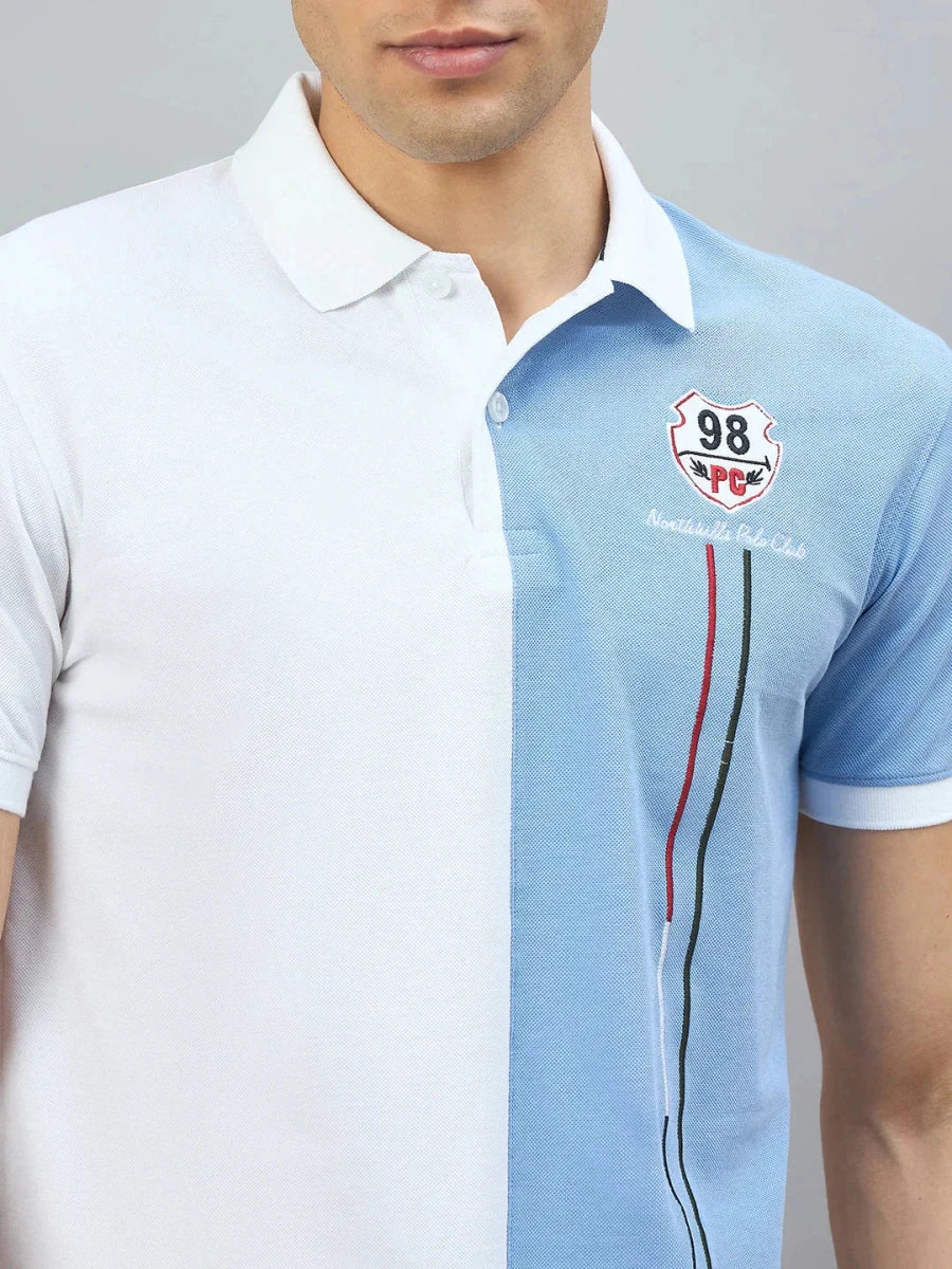 Man wears 98degreenorth White Sky Blue Colour Block Polo T-Shirt with collar and chest logo.
