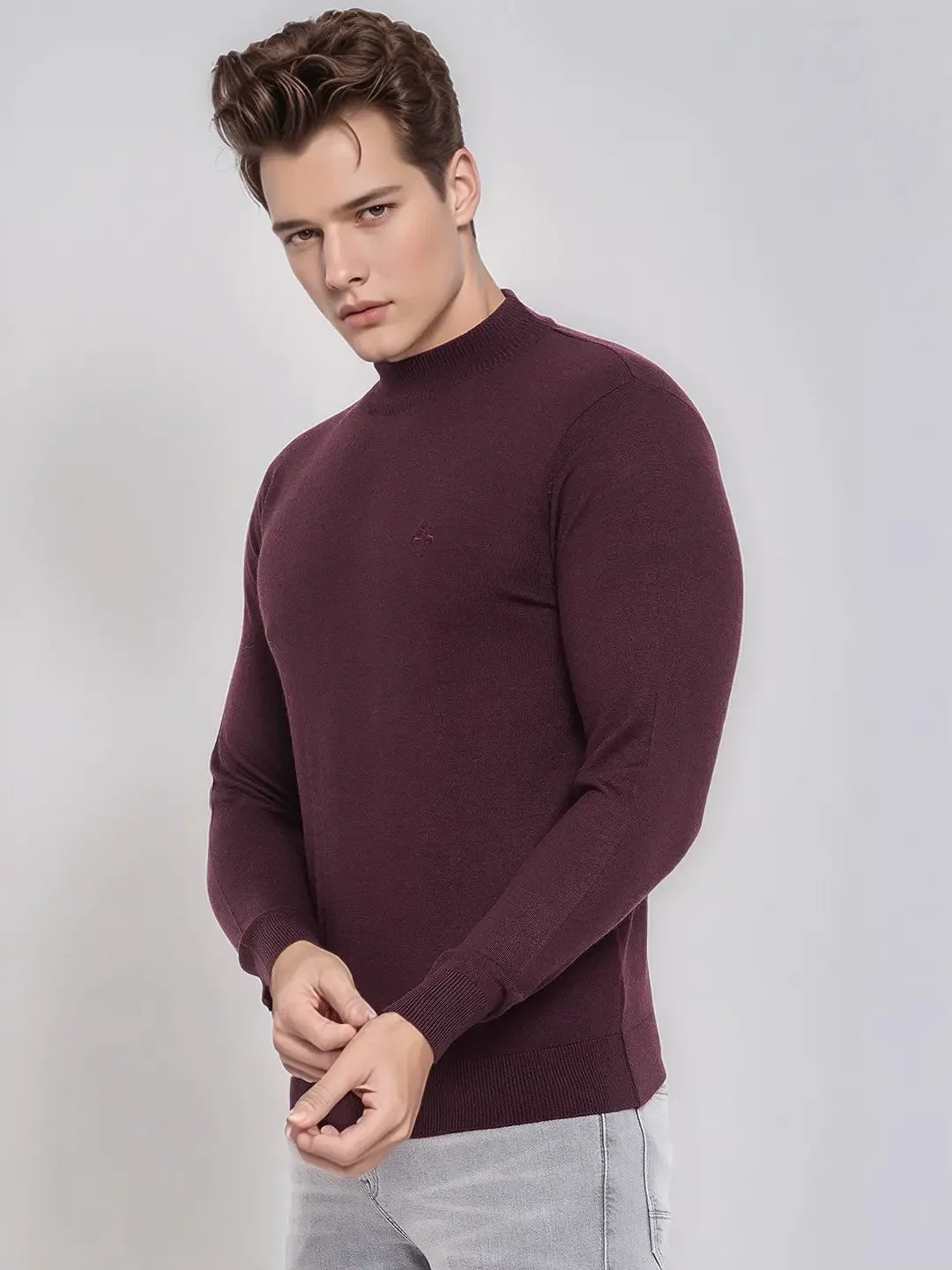 Man in 98degreenorth Men’s Wine Merino Wool Turtle Neck Sweater and light gray pants, against a plain background.