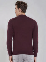 A man in a 98degreenorth wine Merino wool turtle neck sweater and light gray jeans stands facing away against a plain background.