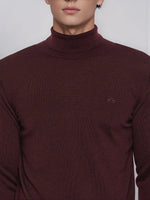 Man in a Men’s Wine Merino Wool Turtle Neck Sweater by 98degreenorth, facing the camera.