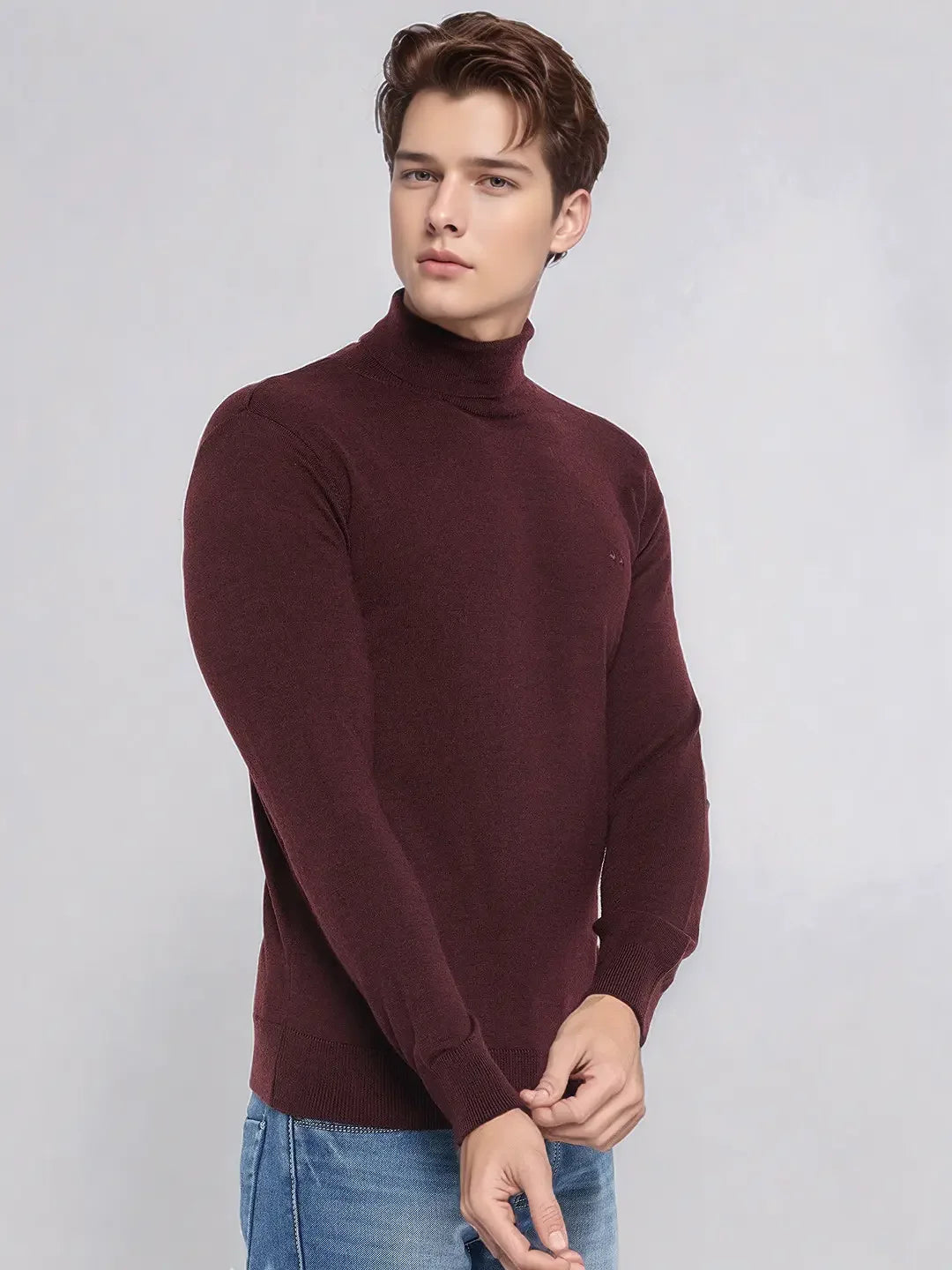 A man models the 98degreenorth Men’s Wine Merino Wool Turtle Neck Sweater, perfect for evenings and travel.