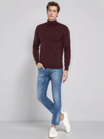 Man in 98degreenorth Men’s Wine Merino Wool Turtle Neck Sweater, blue jeans & white sneakers on light grey background.