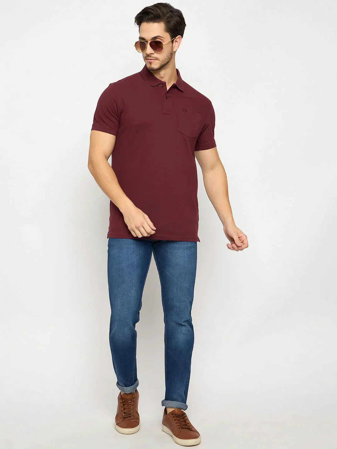 Man in 98degreenorth Men's Wine Polo T-Shirt with chest pocket, blue jeans, brown shoes, sunglasses on white background.