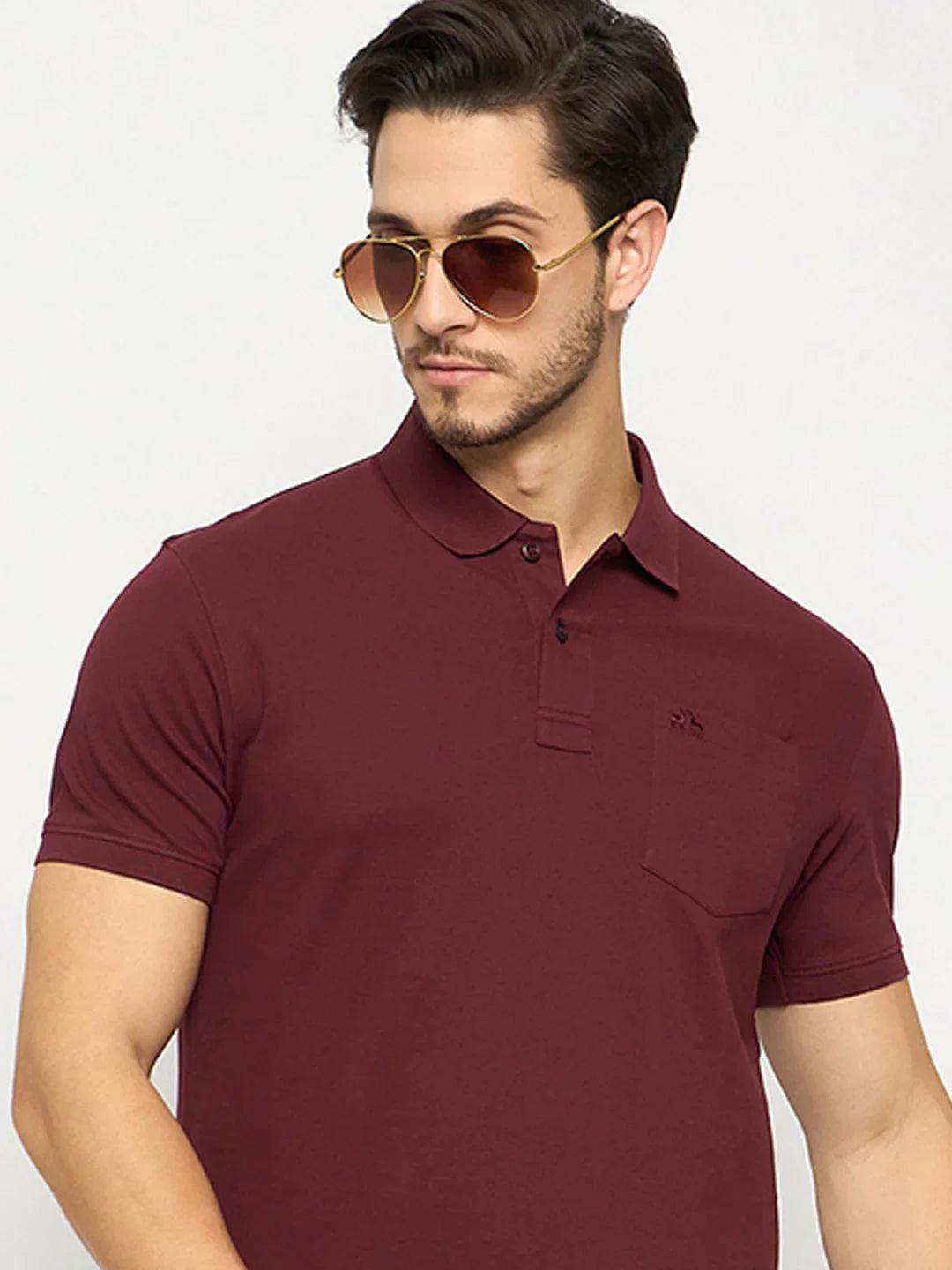Man wears 98degreenorth Men's Wine Polo T-Shirt in stretch cotton pique with chest pocket, looking to the side.