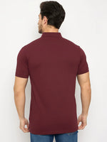 Man wearing 98degreenorth Men's Wine Polo T-Shirt in stretch cotton pique with chest pocket and blue jeans.