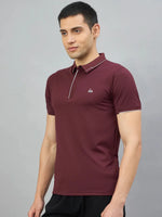 Man wearing 98degreenorth Men's Wine Polo T-Shirt with White Tipping, standing against a plain grey background.