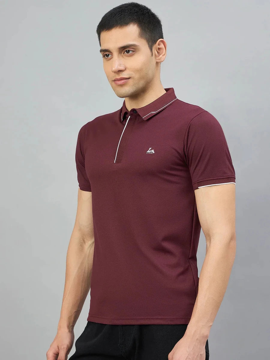 Man wearing 98degreenorth Men's Wine Polo T-Shirt with White Tipping, standing against a plain grey background.