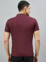 Man wearing 98degreenorth Men's Wine Polo T-Shirt with White Tipping, facing away against a plain gray background.