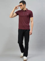 Man in 98degreenorth Men's Wine Polo T-Shirt with White Tipping, black pants, and white sneakers against gray background.