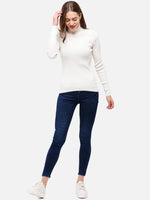 Woman in 98degreenorth Off White Ribbed Turtle Neck Sweater—slim fit knit top, perfect for layering and travel.