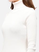 Woman in an Off White Ribbed Turtle Neck Sweater by 98degreenorth—stretchable slim fit, perfect for winter and travel.
