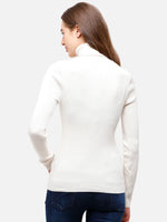 Woman in an off white 98degreenorth ribbed turtleneck slim fit sweater, paired with dark blue jeans – winter fashion India.