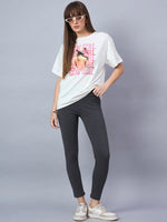 Woman in 98degreenorth Offwhite Typography Graphic Cotton Tee—drop shoulder streetwear—plus black leggings and sneakers.