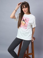 Woman wears 98degreenorth Offwhite Typography Graphic Cotton Tee, poses in black leggings on a stool with sunglasses.