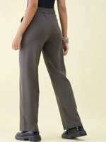 Person in 98degreenorth Olive Wide Leg Pintuck Trackpants—Luxe Lounge vibes, standing with back to camera.