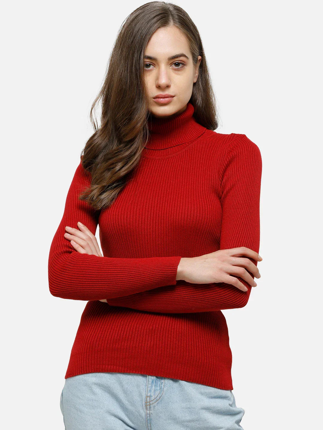 Woman with long brown hair in a 98degreenorth red ribbed stretch turtleneck sweater and light blue jeans, arms crossed.