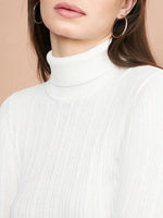 A woman wears the 98degreenorth Ribbed White Turtle Neck Pullover with large hoop earrings. Shown from the shoulders up against a neutral background, her brown hair is down and her lips are lightly colored.