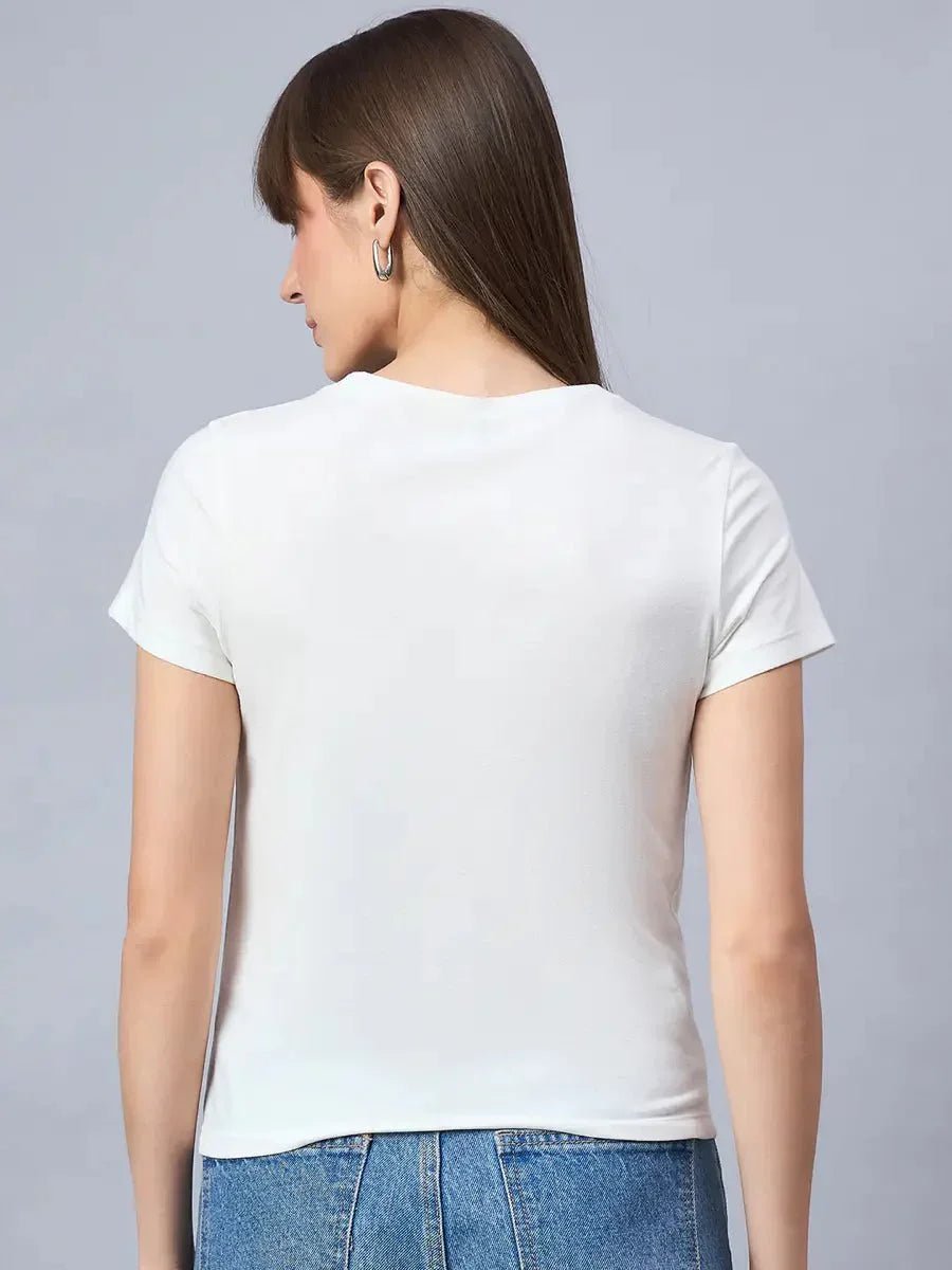 Woman with straight brown hair wears a 98degreenorth round-neck cotton tee with bold print and blue jeans, seen from the back.