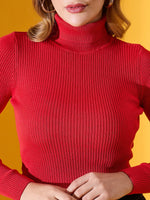 Model in 98degreenorth’s Scarlet Red Ribbed Turtleneck Slim Fit Sweater for Women, styled against a yellow backdrop.
