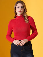 Woman in a 98degreenorth Scarlet Red Ribbed Turtleneck Sweater and dark skirt stands against a yellow background.