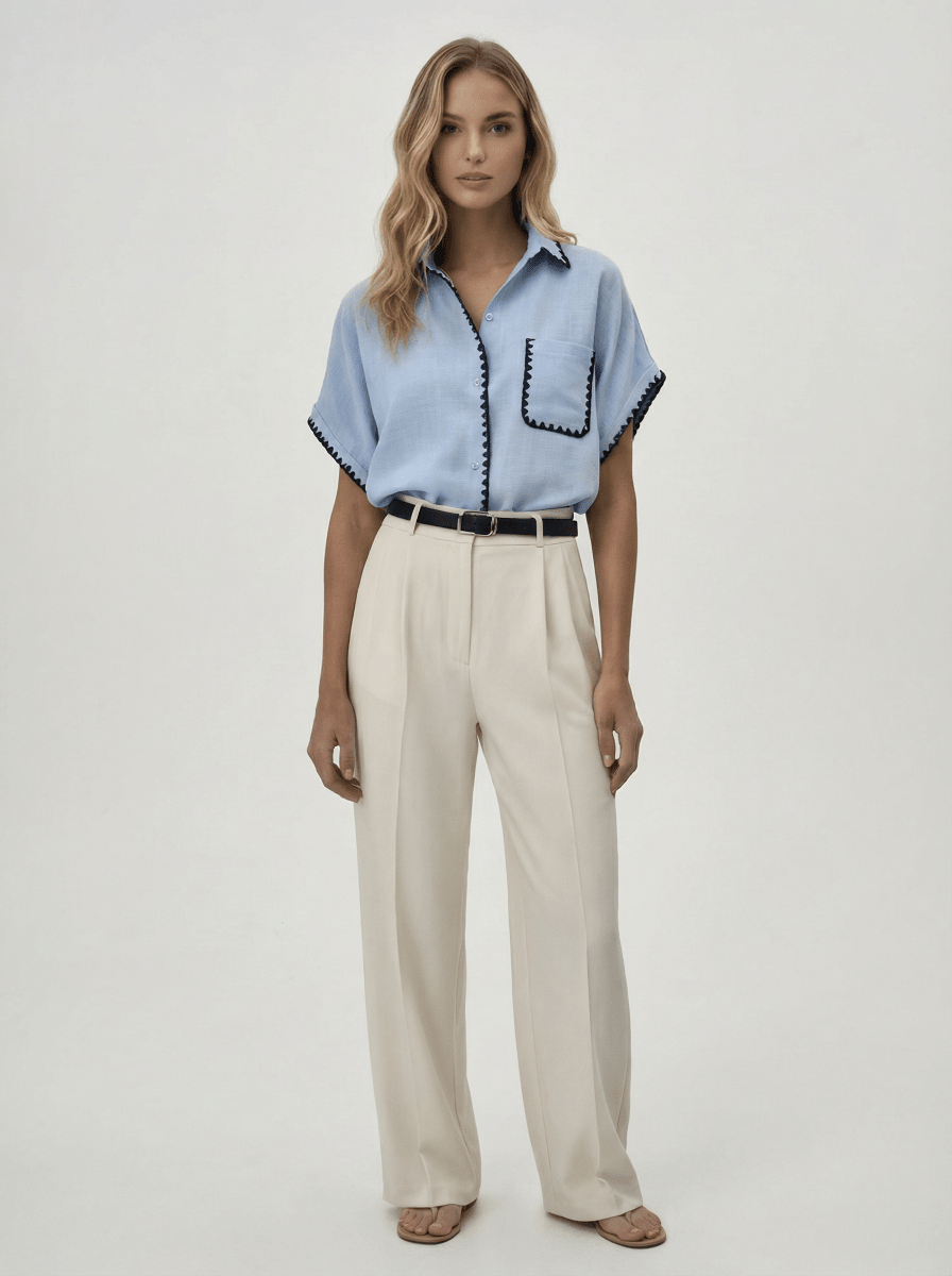 Woman in a Sky Blue Whipstitch Trim Cotton Shirt and beige trousers from 98degreenorth’s Luxe Summer collection.