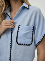 Woman wears 98degreenorth’s Sky Blue Whipstitch Trim Cotton Shirt from the Luxe Summer collection.