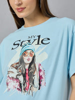 A woman wears the 98degreenorth Soft Cotton Typography Printed Tee with drop shoulder sleeves in urban style.