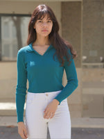 Woman with long brown hair wears the 98degreenorth Teal Ribbed Knit Collared Sweater—chic winter style in natural light.