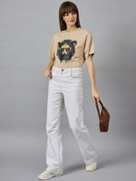 Woman wears 98degreenorths Trendy Typography Oversized Cotton T-shirt, white jeans, and sneakers for streetwear chic.