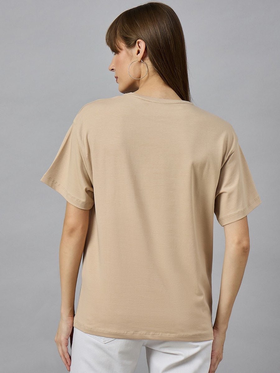 Woman with long brown hair wears 98degreenorths Trendy Typography Oversized Cotton T-shirt, shown from the back.