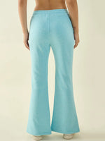 Model wears 98degreenorth Turquoise Blue Women’s Fleece Bootcut Sweatpants, shown from the back against a plain background.