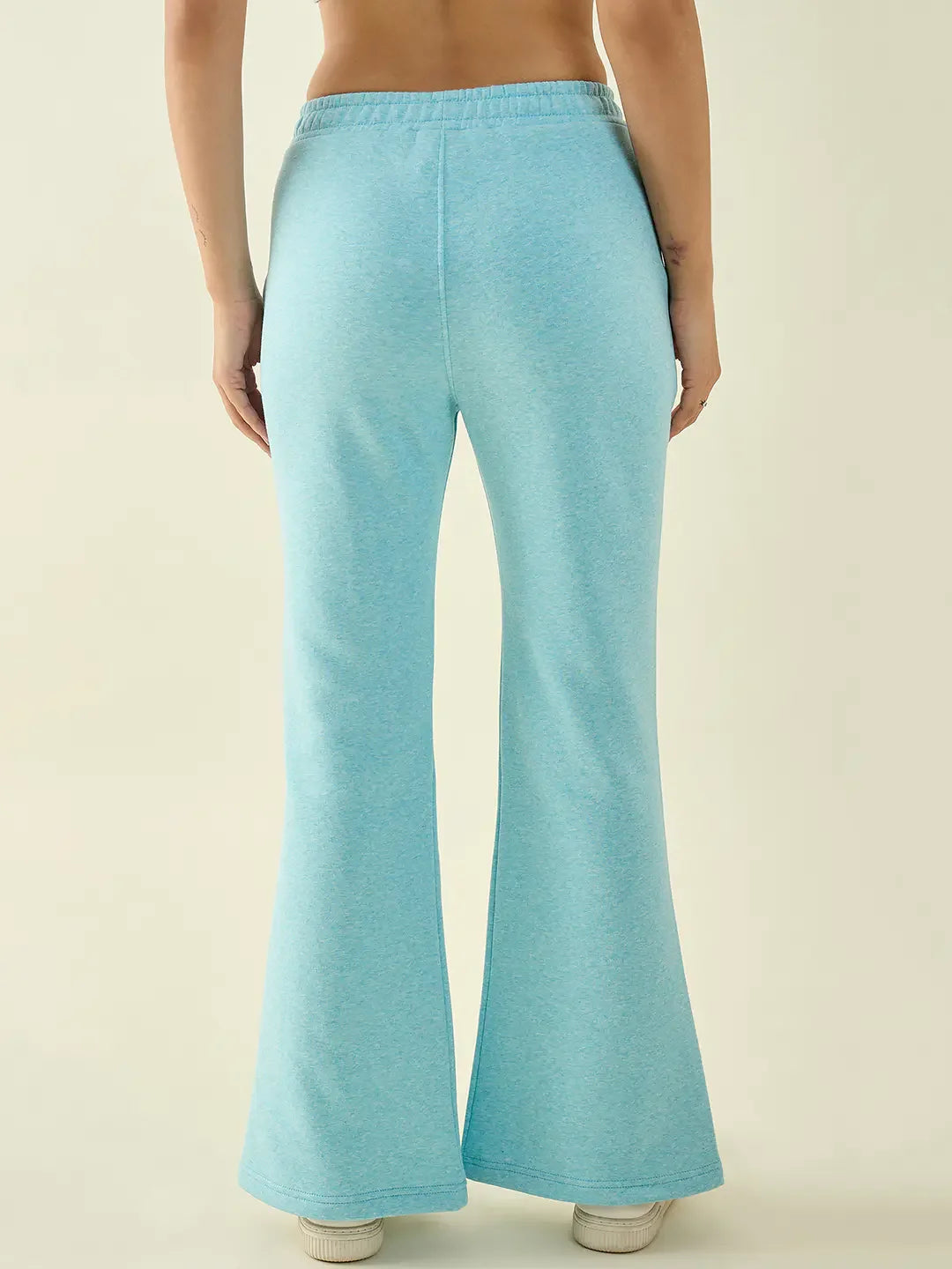 Model wears 98degreenorth Turquoise Blue Women’s Fleece Bootcut Sweatpants, shown from the back against a plain background.