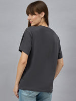 Woman wearing 98degreenorths Typography Graphic Cotton Tee with drop shoulder sleeves, facing away.