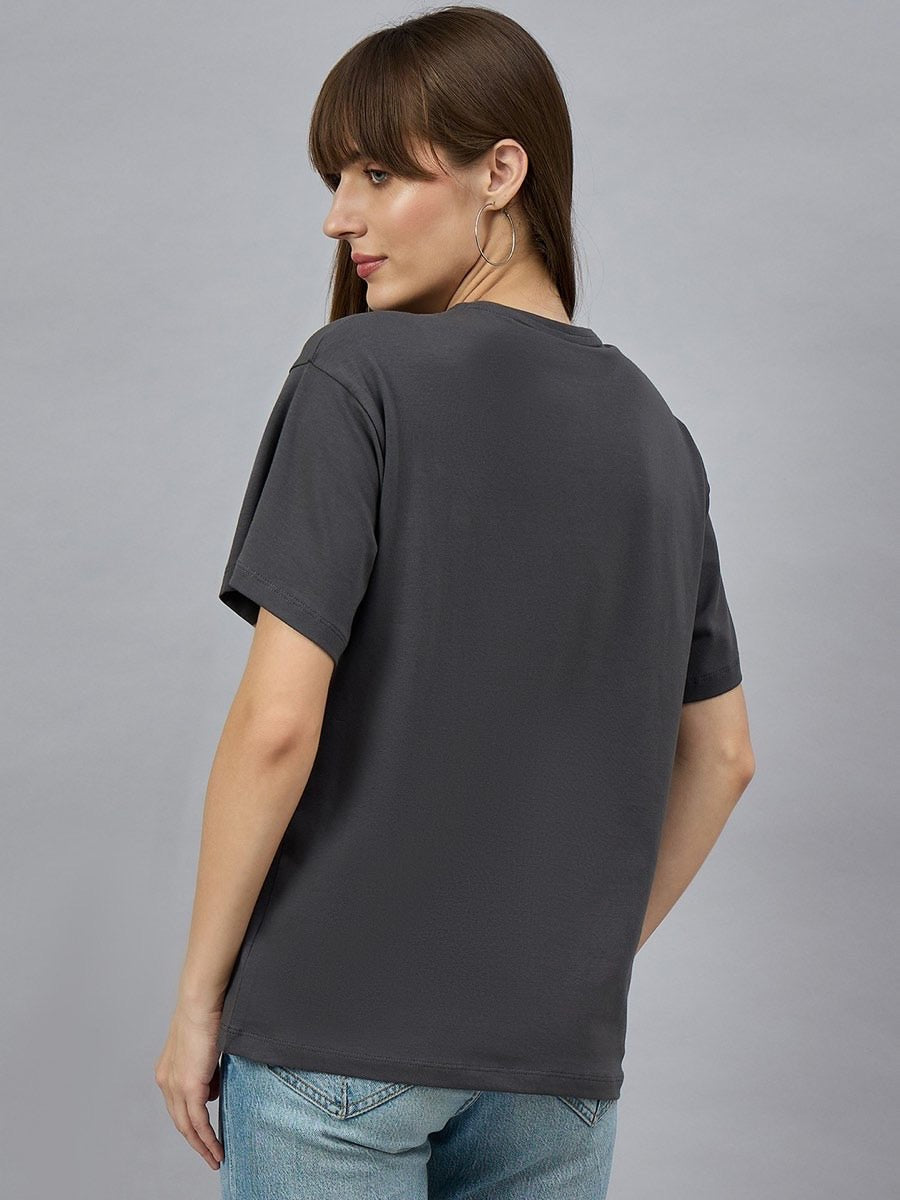 Woman wearing 98degreenorths Typography Graphic Cotton Tee with drop shoulder sleeves, facing away.